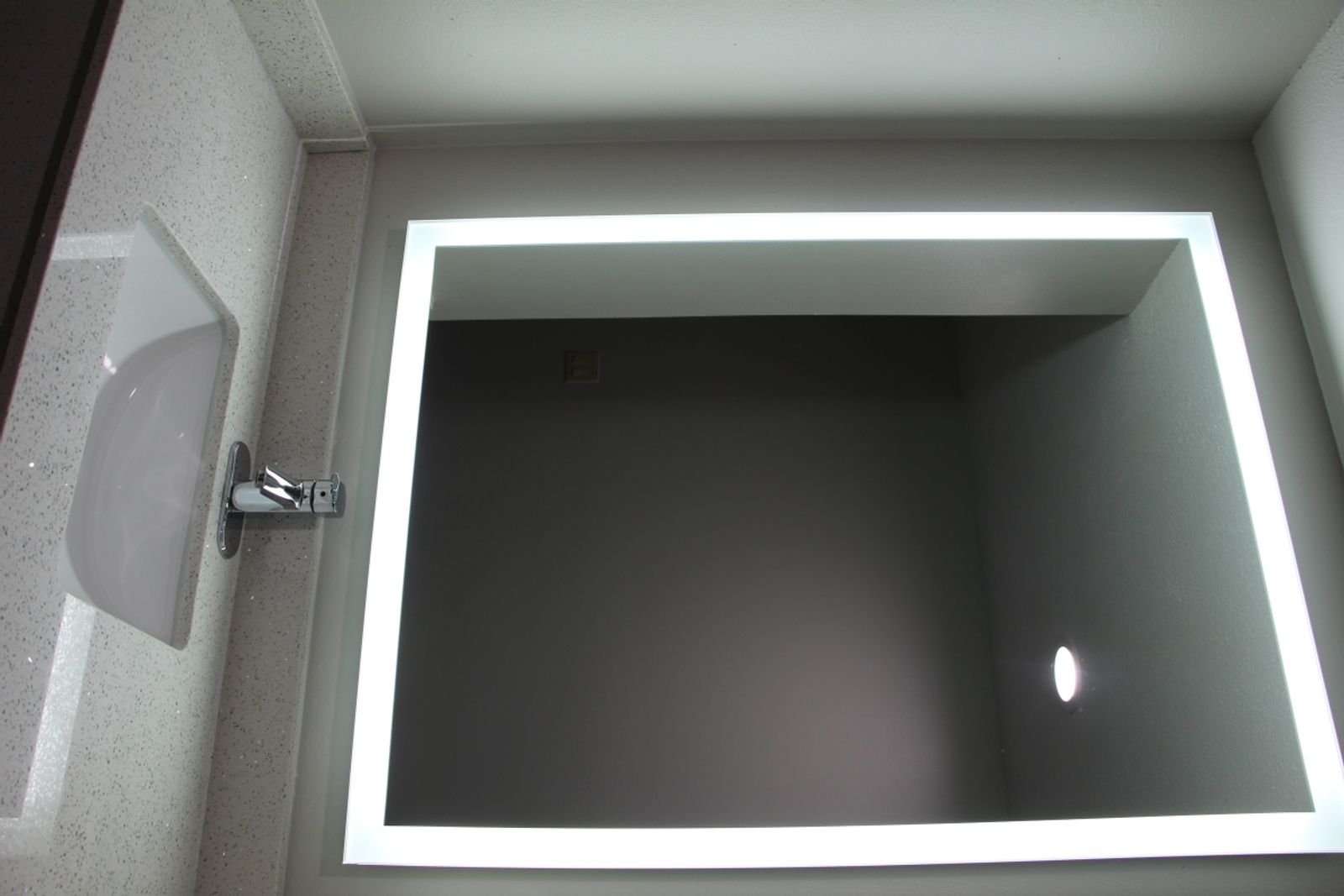 LED-lit bathroom mirror in the Jacuzzi Suite